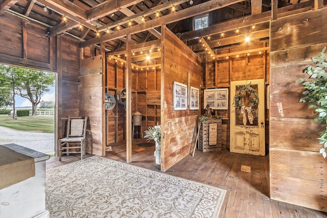 interior space with a towering ceiling and hardwood / wood-style flooring