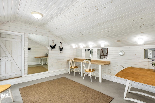 dining area featuring lofted ceiling, wood ceiling, and wooden walls