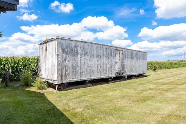 view of outbuilding featuring a lawn