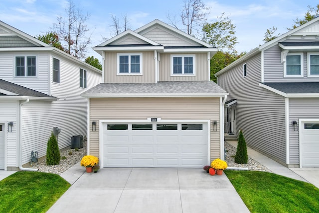 view of front facade with a garage and cooling unit