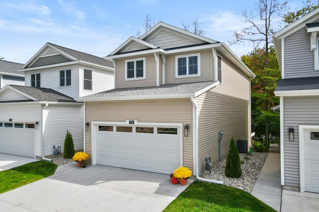 craftsman inspired home with central AC unit and a garage