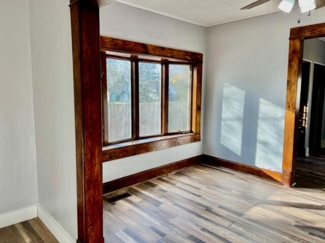 empty room with hardwood / wood-style flooring and ceiling fan