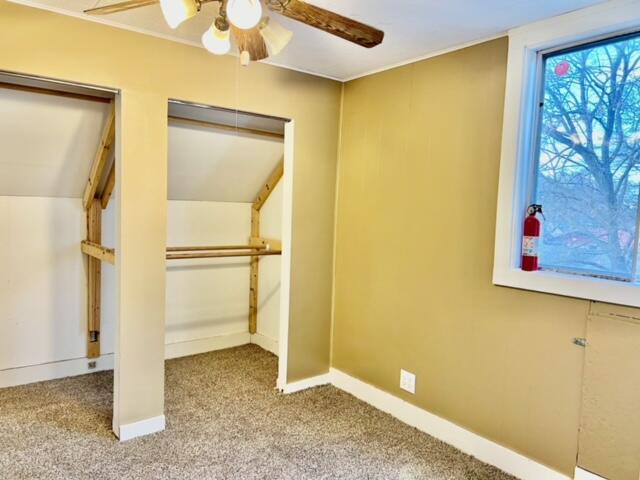 additional living space with ceiling fan, light colored carpet, and lofted ceiling