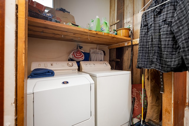 clothes washing area with washing machine and dryer