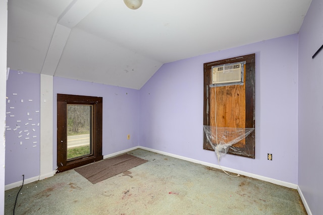 bonus room featuring a wall mounted air conditioner, vaulted ceiling, and carpet flooring