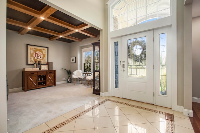 tiled foyer entrance with beamed ceiling and coffered ceiling