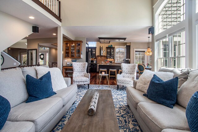 living room with a towering ceiling and hardwood / wood-style floors