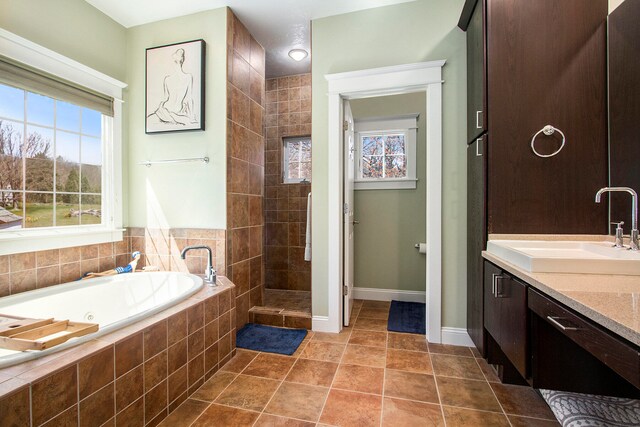 bathroom featuring vanity, shower with separate bathtub, and tile flooring