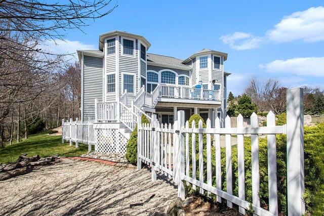 rear view of house featuring a deck