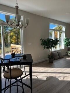 412 Coventry Rd, Battle Creek, MI 49015 - dining space featuring baseboards, wood finished floors, and a chandelier