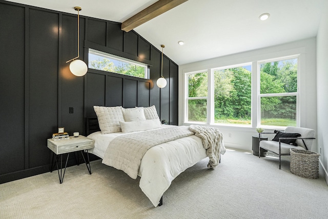 carpeted bedroom with vaulted ceiling with beams