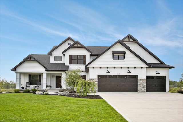 modern farmhouse style home featuring a garage, a front lawn, and covered porch