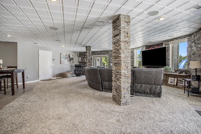 carpeted living room with ornate columns