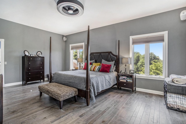 bedroom featuring multiple windows and hardwood / wood-style floors