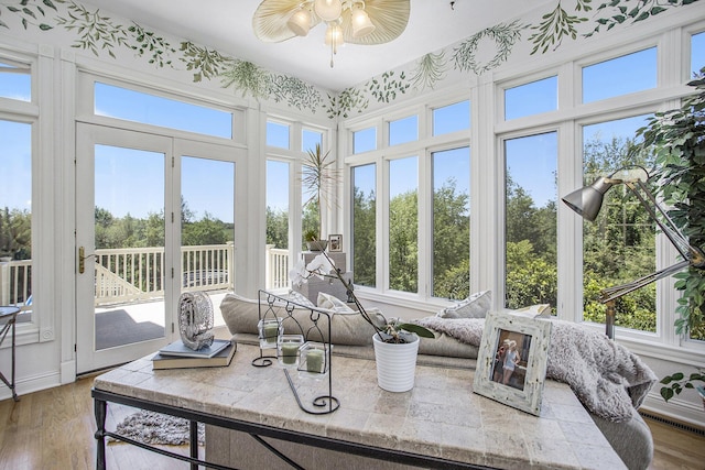 sunroom featuring ceiling fan