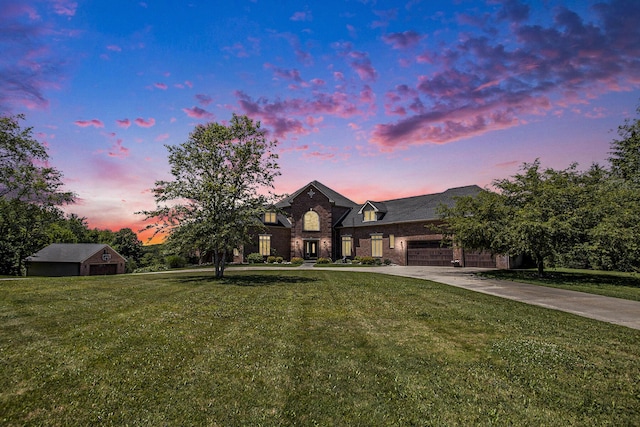 view of front of property featuring a garage and a lawn