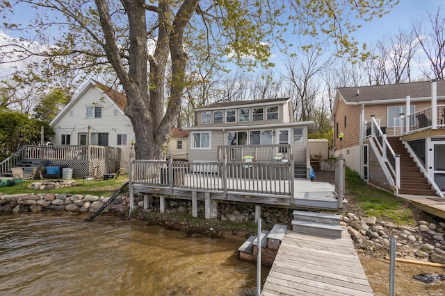 rear view of property with a deck with water view