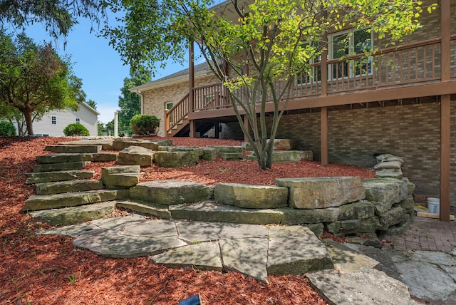 exterior space with stairway and a wooden deck