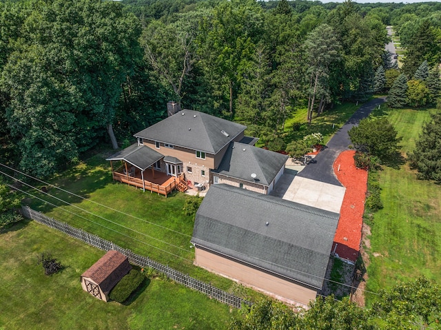 birds eye view of property featuring a wooded view