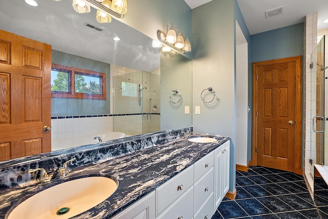 bathroom with tile patterned floors, a sink, visible vents, and a shower stall