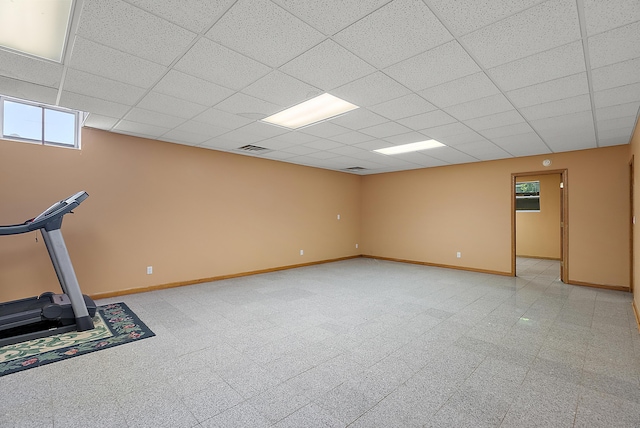 workout room featuring visible vents, baseboards, and a drop ceiling