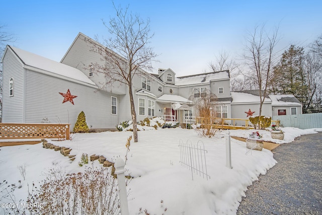 view of snow covered back of property