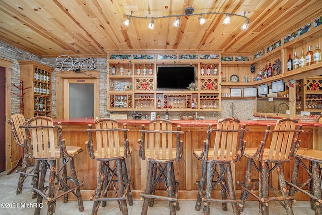 bar with wooden ceiling and rail lighting