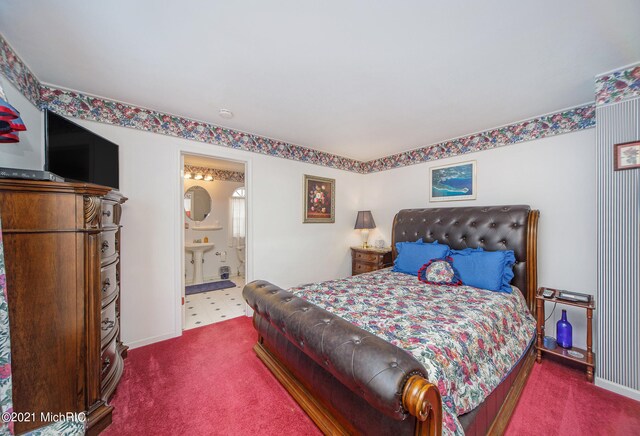 bedroom featuring connected bathroom and carpet flooring