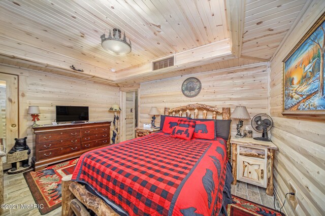 bedroom with wood ceiling and hardwood / wood-style floors