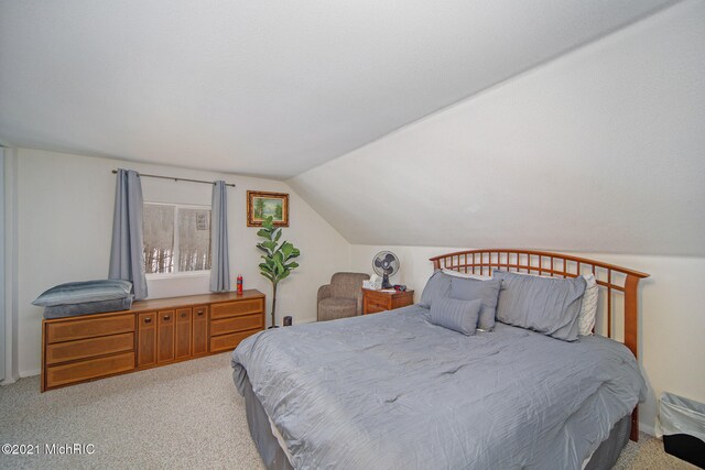 carpeted bedroom with vaulted ceiling