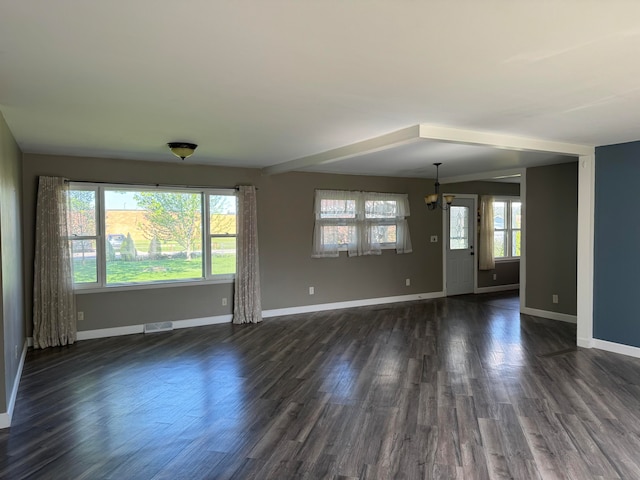 spare room featuring dark wood-type flooring