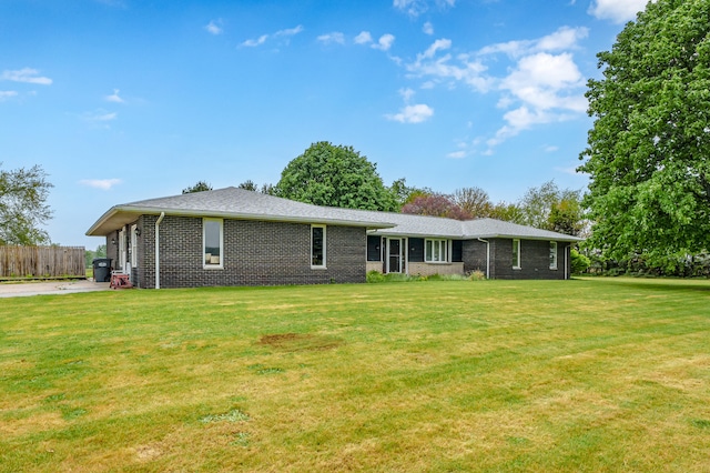 back of property featuring a yard