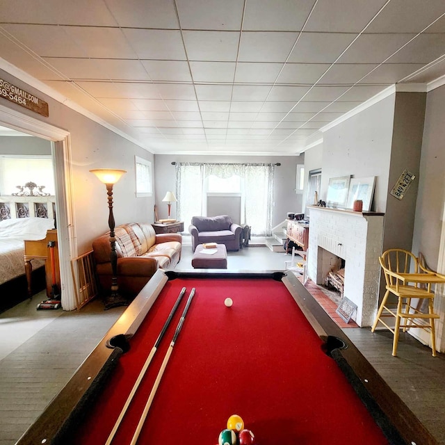 playroom featuring crown molding, a fireplace, and billiards