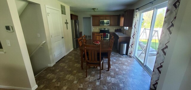 tiled dining room with sink