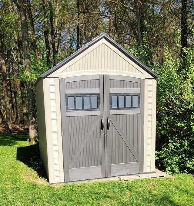 view of outbuilding featuring a yard