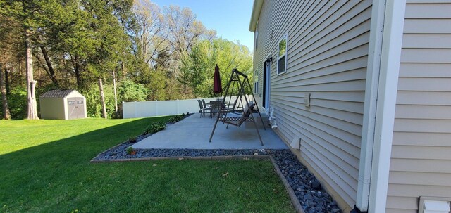 view of yard featuring a patio area and a storage unit