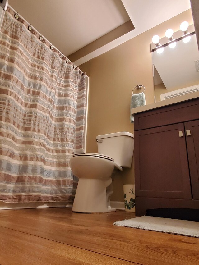 bathroom featuring vanity, toilet, and hardwood / wood-style flooring