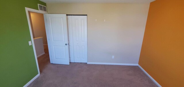 unfurnished bedroom featuring a closet and carpet flooring