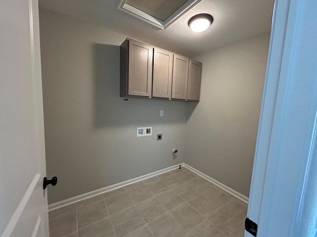 laundry room with electric dryer hookup, cabinets, light tile patterned floors, and hookup for a washing machine