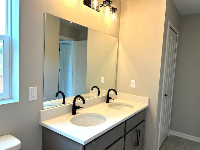 bathroom featuring tile patterned floors, vanity, and toilet