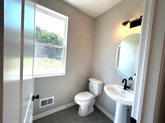 bathroom featuring tile patterned floors and toilet