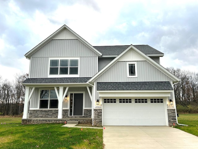 craftsman-style house featuring a front lawn and a garage