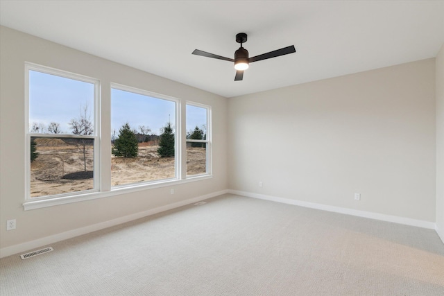 empty room with ceiling fan and carpet flooring