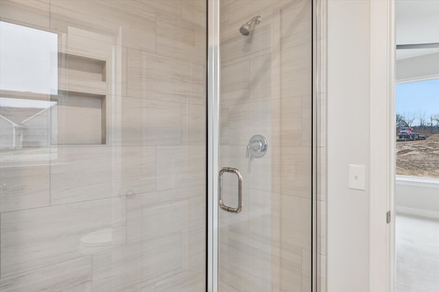 bathroom with a shower with door