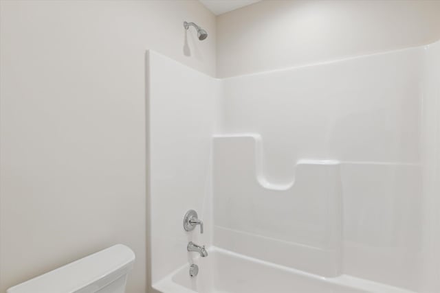 bathroom featuring toilet and  shower combination