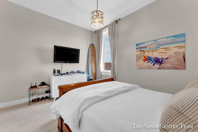 bedroom featuring an inviting chandelier and carpet