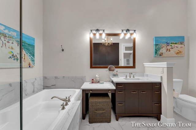 bathroom with a notable chandelier, tiled bath, vanity, and toilet