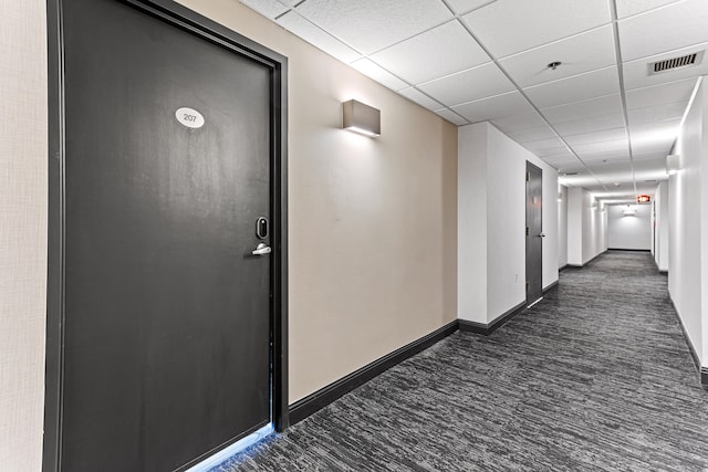 hallway featuring a paneled ceiling