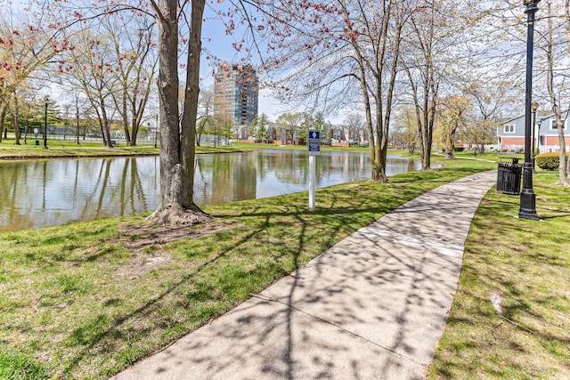 view of community with a water view and a lawn