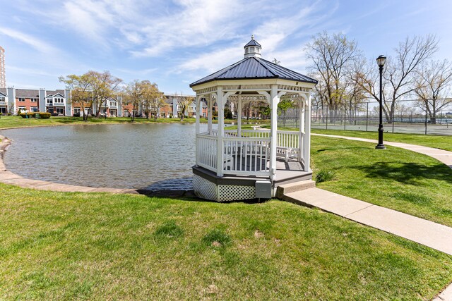 dock area with a yard, a gazebo, and a water view